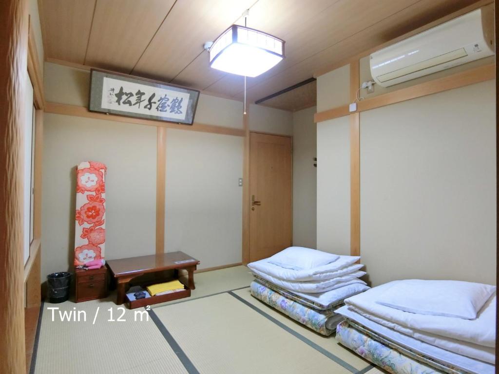Kyoraku Ryokan Tatami Room Futons Table