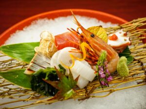 Sashimi assortment on a woven platter over ice