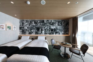 Twin beds and small seating area in guest room