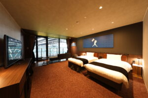 Twin beds in a dark modern guest room