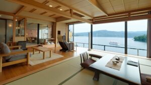 Tatami room with low table, chairs, and lake view