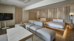 Bedroom with two beds and sofa seating area