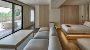 Guest room with beds, sofa, and outdoor bath