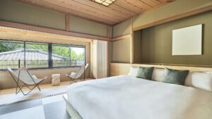 Large bed beside window seating in a tatami room