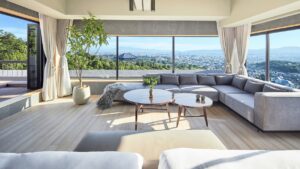 Living area with sectional sofa and city view windows