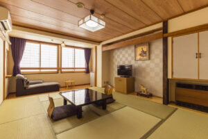 Tatami room with low table, floor chairs, and bench