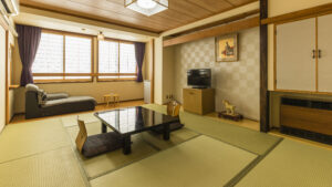 Tatami room with low table, floor cushions, and sofa