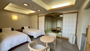 Twin beds beside a tatami seating area