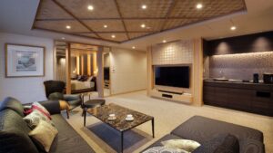 Sala de estar con sofá, sillas, mesa y televisión