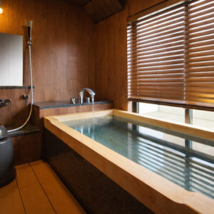 Baño privado de madera lleno de agua junto a la ventana