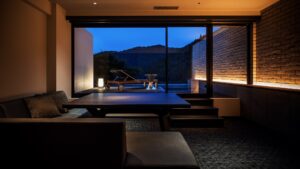 In-room seating area facing terrace and mountain view