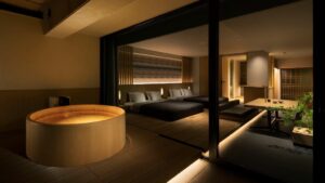 Private wooden tub beside a modern tatami guest room
