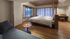 Bed in Japanese-style guest room with sofa and desk