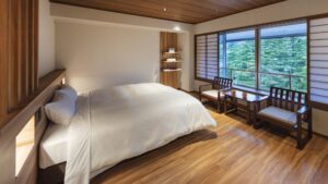 Bedroom with large bed by window seating area