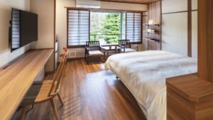 Guest room with bed, desk, and window seating