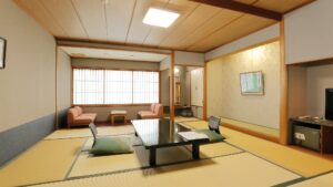 Tatami guest room with low table and sofa seating