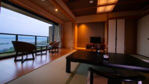 Tatami room with low table, chairs, and lake view
