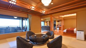 Tatami room with round table, chairs, and bed area