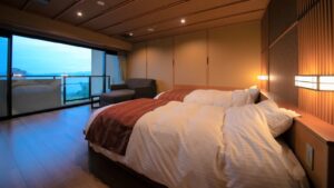 Two beds beside a window with lake view