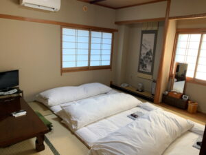 Futons laid out in a tatami guest room