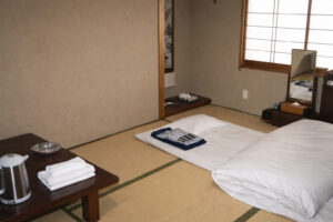 Futons laid out in a tatami guest room