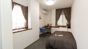 Single bed in a compact guest room