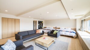 Guest room with beds, sofa, and coffee table