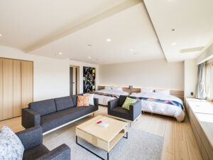 Guest room with sofa seating and two beds