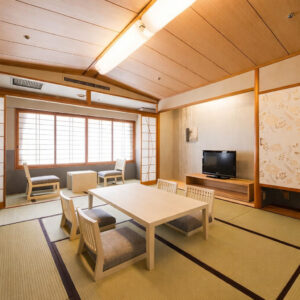 Tatami room with low table, chairs, and window seating