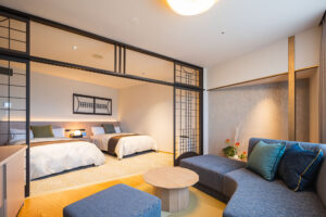 Guest room with twin beds and sofa seating area