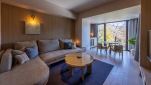 Zona giorno con divano, tavolo e posti a sedere accanto alla finestra