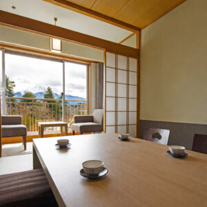 Table et chaises dans une chambre en tatami près de la fenêtre du balcon