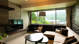 Zona de estar con sofá junto a una gran ventana en la habitación