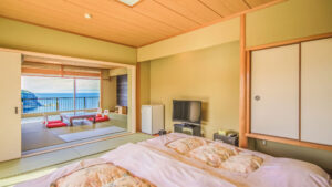 Futons in a tatami room with seaside seating area