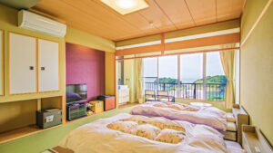 Futons laid out beside window overlooking water