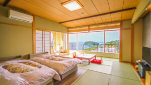 Tatami guest room with twin beds and ocean view