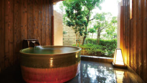 Private round bath beside an open garden window