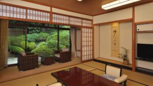 Tatami room with low table and chairs by garden window