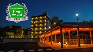 Hotel exterior at night with award graphic