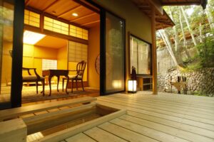 Private wooden bath beside room terrace and seating area