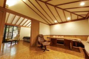 Room with table, chairs, and adjacent sleeping area