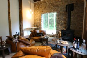 配有皮椅和燃木炉的起居区