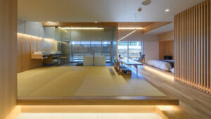 Modern tatami room with low bed and glass bathroom