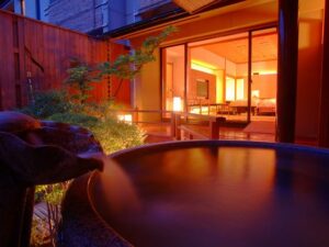Open-air bath beside sliding doors to the room