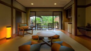 Tatami room with low table, floor cushions, and chairs