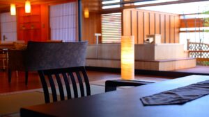 Tatami room with table, chairs, and open-air bath