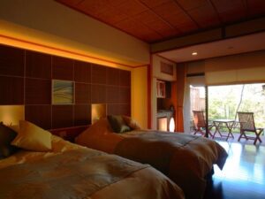 Two beds in a guest room with balcony seating