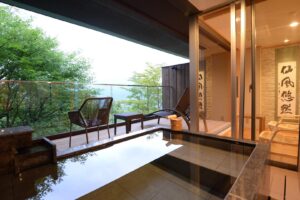 Bain en plein air privatif près des sièges du balcon et des arbres