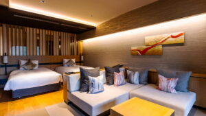 Lits jumeaux et coin salon avec canapé dans une chambre