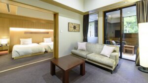 Sofa and table beside bedroom in ryokan suite